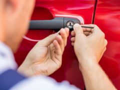 Person Opening Car Door With Lockpicker