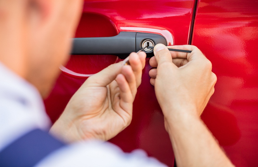 Person Opening Car Door With Lockpicker